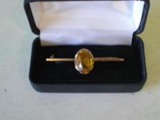 A Gold Bar Brooch Set with a citrine