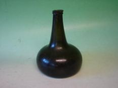 An 18th Century Wine bottle Of onion form green glass. 7 ½" high