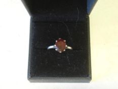 A Platinum Ring Solitaire set with a garnet