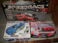 Two Radio Controlled Model Cars Together with a racing car track set