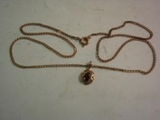 A 9ct Pendant and Chain Set with a red stone