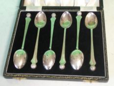 A Cased Set of Six Silver Teaspoons With golf ball terminals. Birmingham 1954