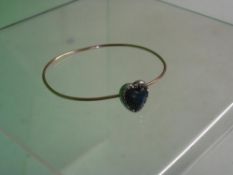 A Gold Bangle With a blue cabochon and diamond heart in gold backed silver setting