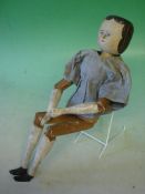 A Grodner Tal Wooden Doll With painted hair and features. Peg jointed at shoulders, elbows hips