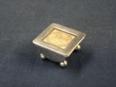 A Victorian Silver Stamp Box The hinged sprung lid inset with a penny stamp under glass, on ball
