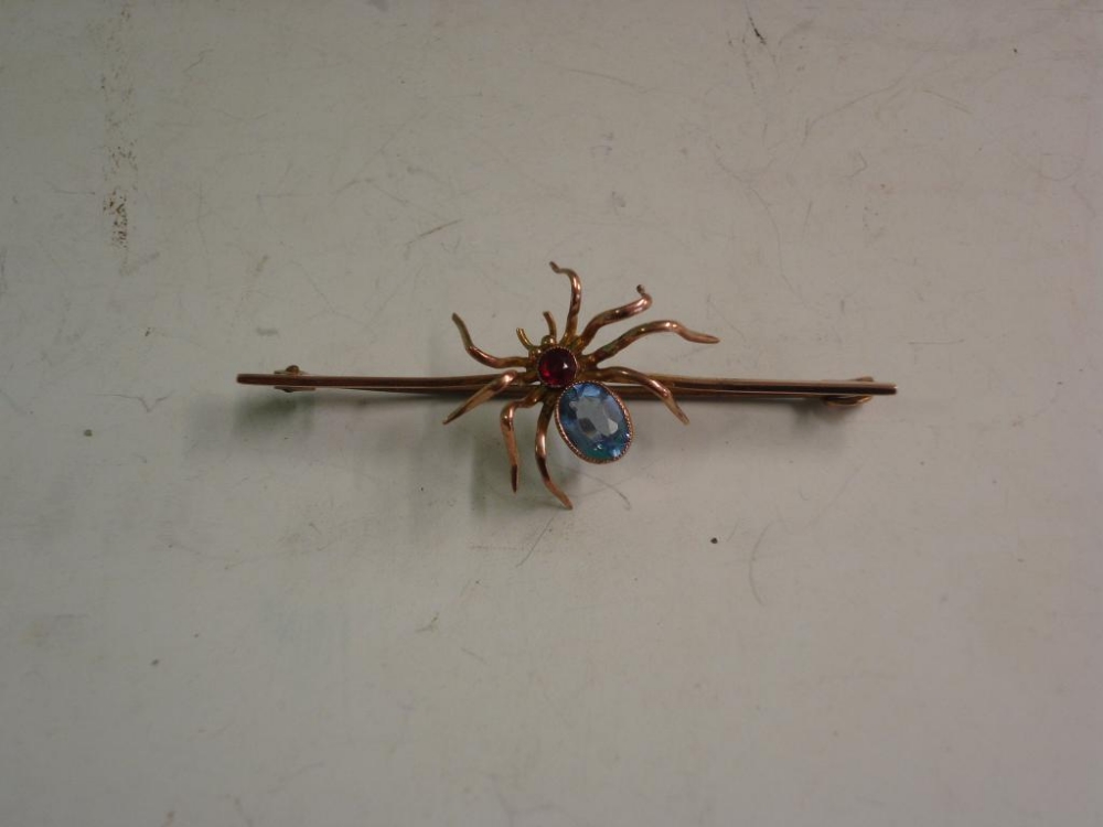 A 9ct Spider Bar Brooch Set with red and blue stones
