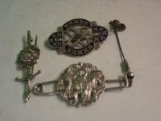 Three Silver Brooches. Together with a tie pin