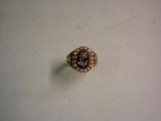 An Early Victorian 18ct Mourning Ring The jet table with diamond set flower within a border of split