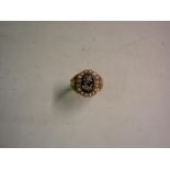 An Early Victorian 18ct Mourning Ring The jet table with diamond set flower within a border of split