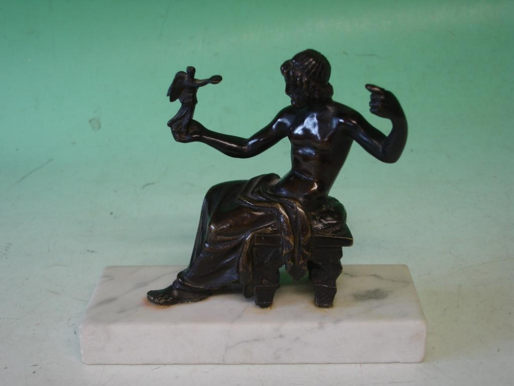 Grand Tour A bronze group of a seated man receiving an offering from an angel standing in his