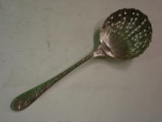 A White Metal Sifter Spoon With shell form bowl, the handle relief decorated with birds and foliage.