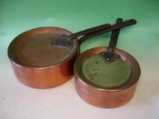 Two copper saucepans With Covers Stamped Temple and Crook. Iron handles. The larger 11 ½" diam.