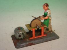 An Arnold Tinplate Clockwork Toy The scissor sharpener, U.S. zone Germany. 5 ¾" long