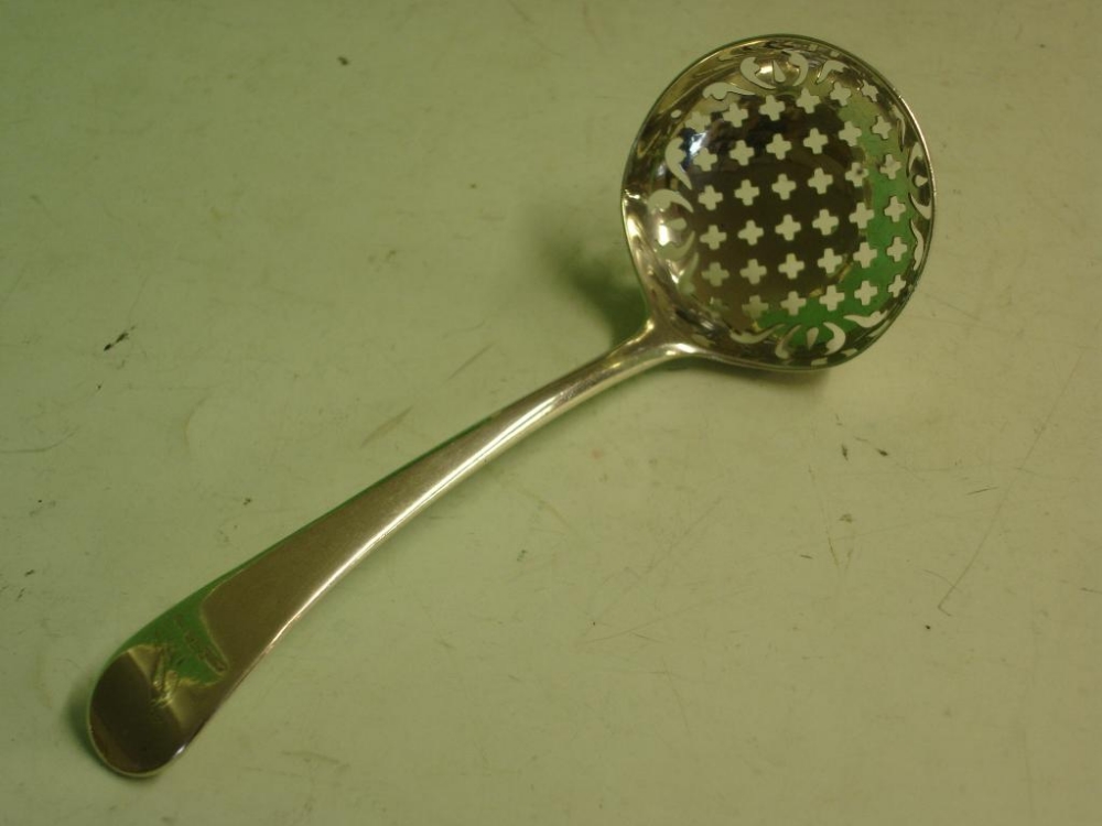 A Silver Sifting Ladle Hanoverian pattern, the handle engraved with an armorial. London 1782-83