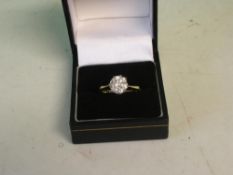 A Diamond Solitaire Ring With a round brilliant cut diamond, in gold marked 18ct. Size N. The