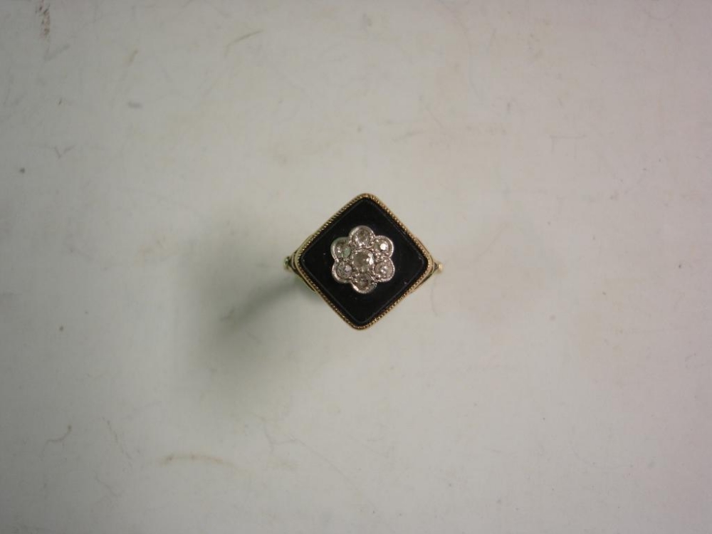 A Victorian 18ct Mourning Ring Cluster set with seven diamonds on a square jet table