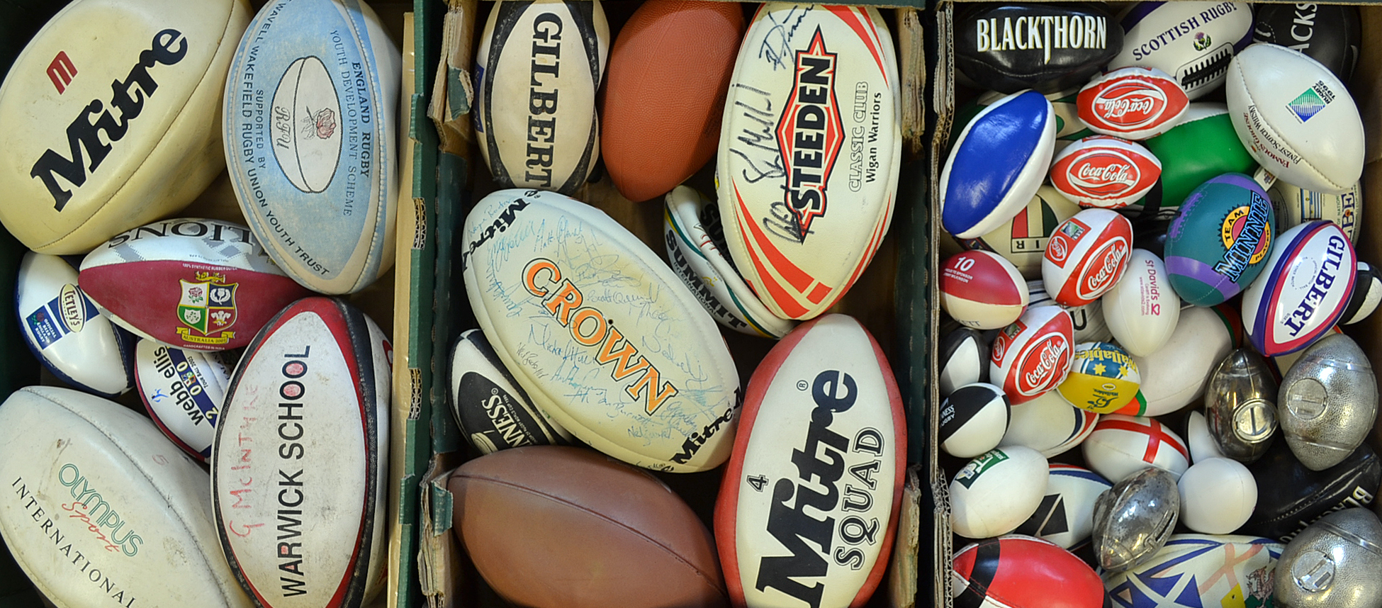 Quantity of rugby balls and money boxes including 1993 Wales team signed, Wigan Warriors signed