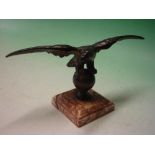 A Bronze Desk Weight. Formed as an eagle with spread wings, raised on a specimen marble base.