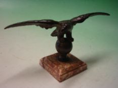 A Bronze Desk Weight. Formed as an eagle with spread wings, raised on a specimen marble base.