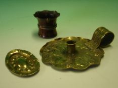 Arts and Crafts Metalware a brass chamberstick, a small embossed oval dish and a miniature copper