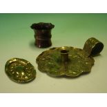 Arts and Crafts Metalware a brass chamberstick, a small embossed oval dish and a miniature copper