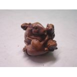 A Japanese Wood Netsuke carved as a group of five mice. Signed. (One glass eye lacking)