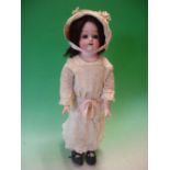 A Japanese Porcelain Doll. The head with open eyes and mouth, jointed leatherette body, the nape