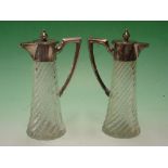 A Pair of French Carafons Wrythen moulded bodies with silver mounts and handles. 7 ½" high. Early