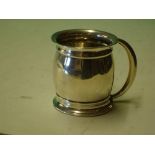 A Silver Mug of bulbous form with crescent handle. 2 ¼" high. Birmingham 1911. 19dwts