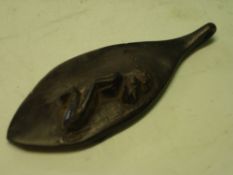 African Art. An ebony pendant of oval form, carved with a kneeling figure. 3 ½" long