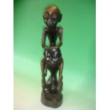 Ethnic Art. An African carved wood group with geometric and animal painted decoration