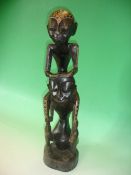 Ethnic Art. An African carved wood group with geometric and animal painted decoration