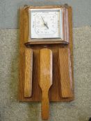 An Oak Aneroid Barometer. Shortland Smiths. Fitted with three clothes brushes. 15" high
