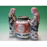 Chinese Porcelain. A famille verte group of two female attendants standing with a large vessel,