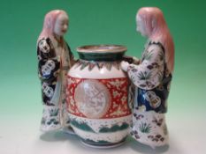 Chinese Porcelain. A famille verte group of two female attendants standing with a large vessel,