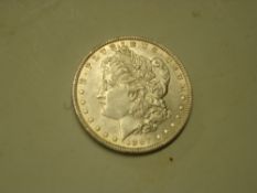 Coins. An 1887 Morgan silver dollar
