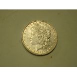 Coins. An 1887 Morgan silver dollar