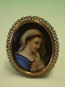 A Continental Porcelain Plaque finely painted with a female bust, the scroll pierced gilt metal
