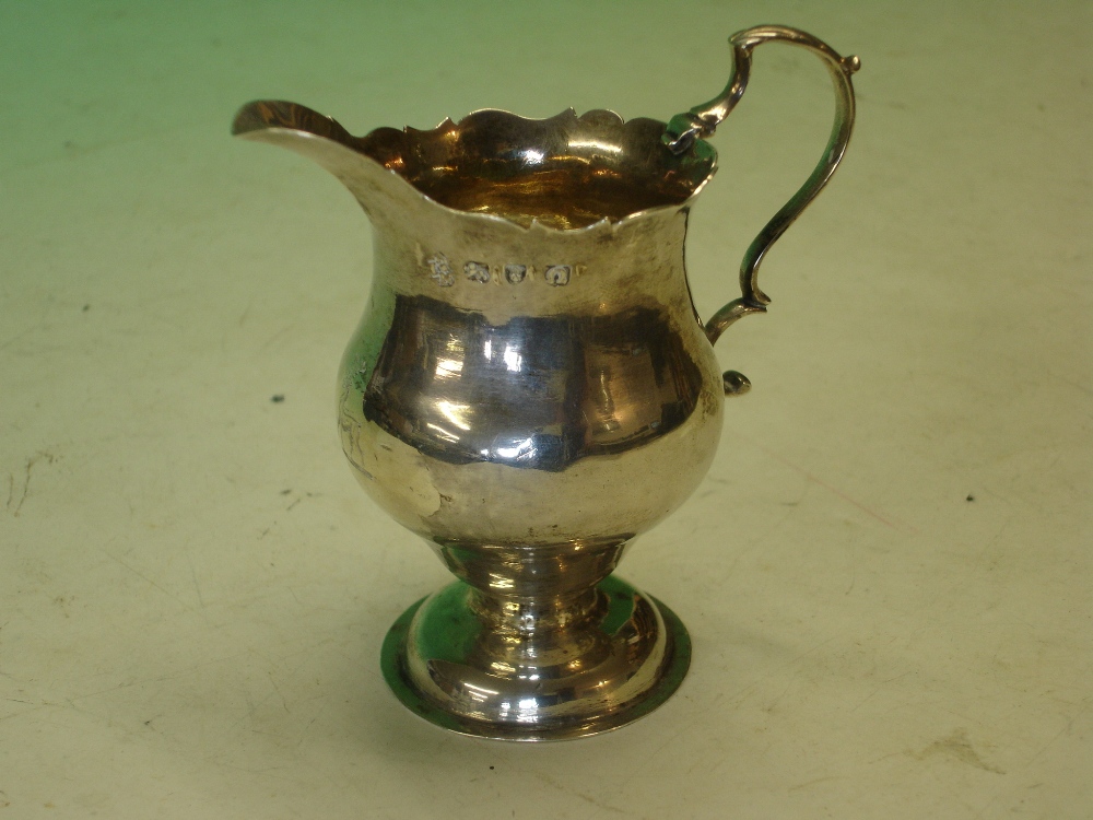 Silver Cream Jug of helmet form with double scroll handle. Crested. London 1768. 3 ¾" high. 2ozs