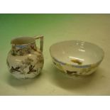 An Oriental Jug and Bowl decorated with landscape, birds and prunus. The bowl 5 ¼" diam