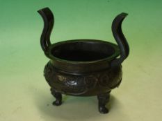 A Chinese Archaistic Bronze Censer. Compressed circular with riveted serpentine handles, decorated