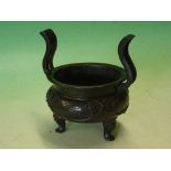 A Chinese Archaistic Bronze Censer. Compressed circular with riveted serpentine handles, decorated