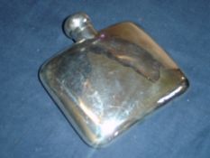 A Silver Hip Flask of curved form with locking hinged lid. 4 ½" wide. Birmingham 1901. 2ozs 18dwts