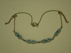 A Silver and Blue Enamel Necklet of foliate design, each flower head set with a marcasite. 1920s