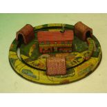A Tinplate Model Railway. The building to the centre housing the clockwork motor that powers the