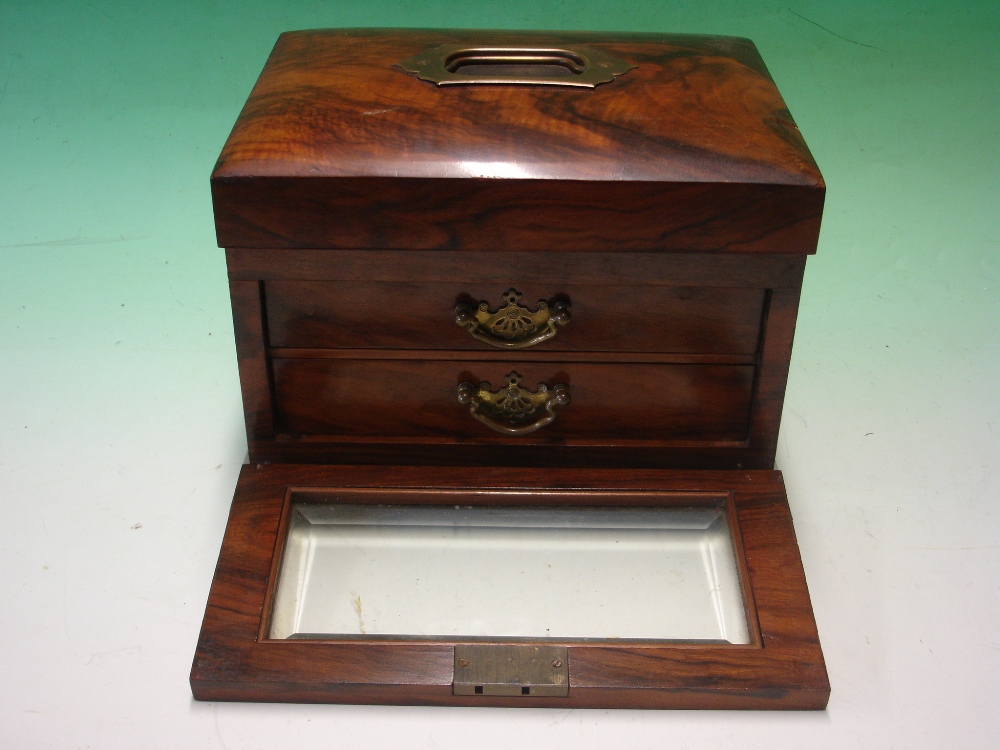 A Victorian Walnut Jewellery Case, the slightly domed lid over a glazed fall front enclosing a