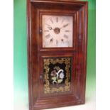 An American Wall Clock. Weight driven movement, mahogany veneered case. 30" high