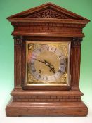 An Oak Mantel Clock. Architectural case. The 8 day movement striking the hours and quarter hours