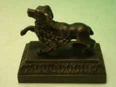 A Bronze Desk Weight formed as a poodle on a moulded stepped base. French, 19th century