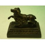 A Bronze Desk Weight formed as a poodle on a moulded stepped base. French, 19th century